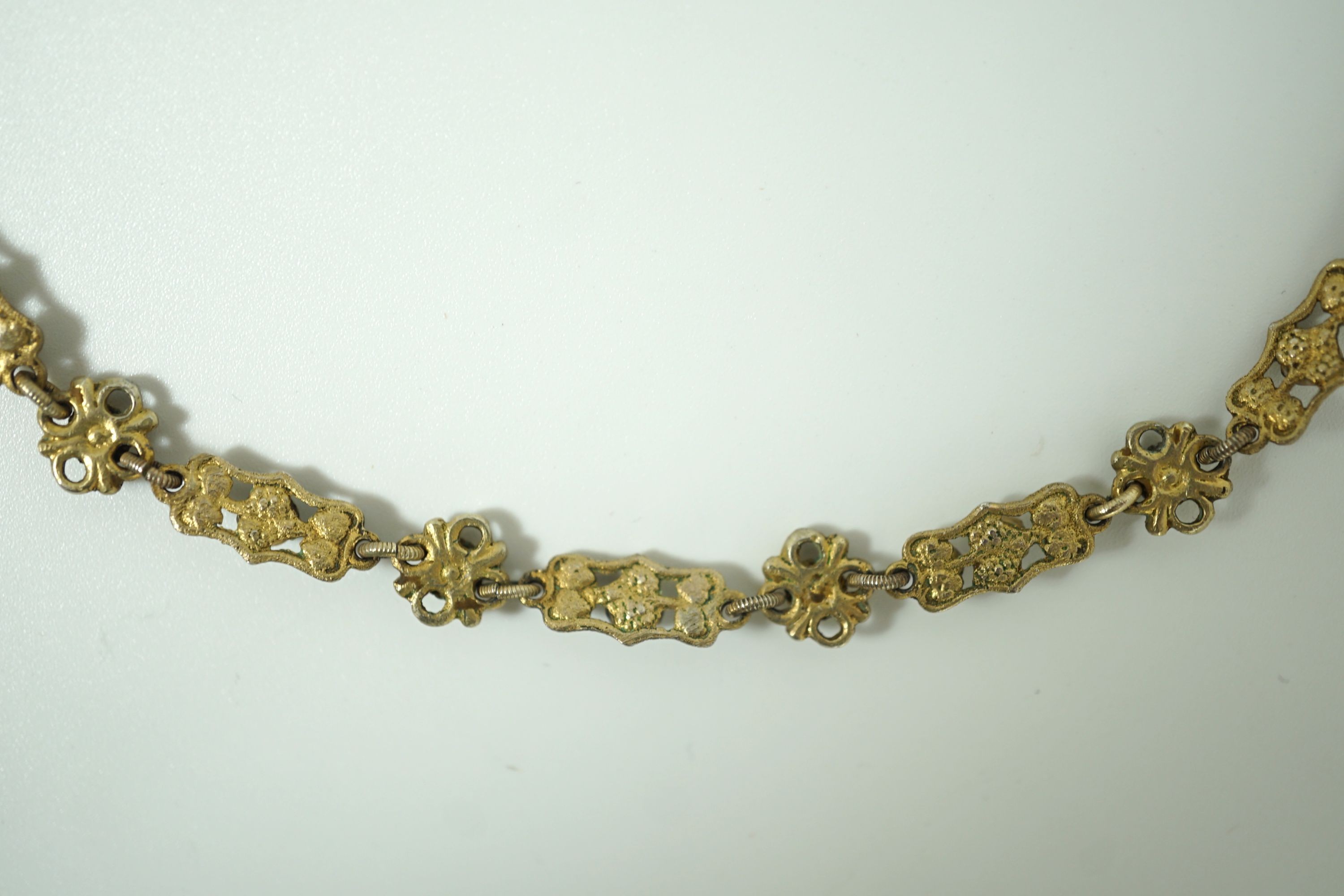 An early 20th century pierced and engraved silver gilt and gem set choker necklace, in the Suffragette colours